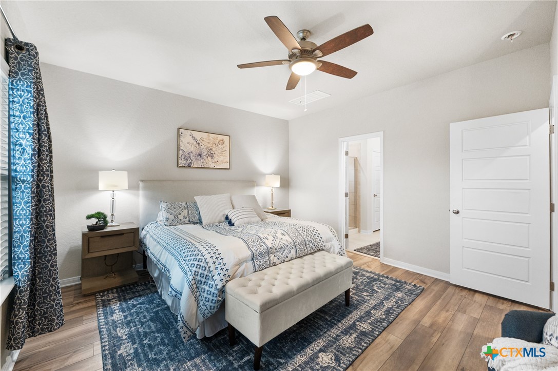 232 Colebrook Way Cibolo, TX 78108 - Photo 19 of 42 a spacious bedroom with a bed and a chandelier