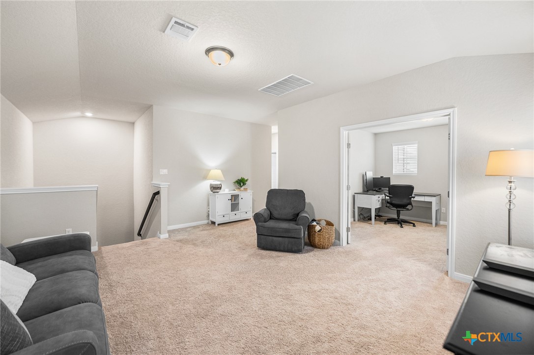 232 Colebrook Way Cibolo, TX 78108 - Photo 27 of 42 a living room with furniture and a lamp