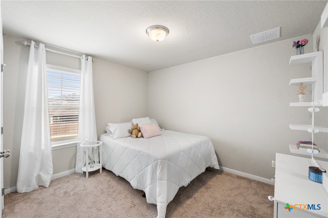 232 Colebrook Way Cibolo, TX 78108 - Photo 30 of 42 a bedroom with a bed and a window