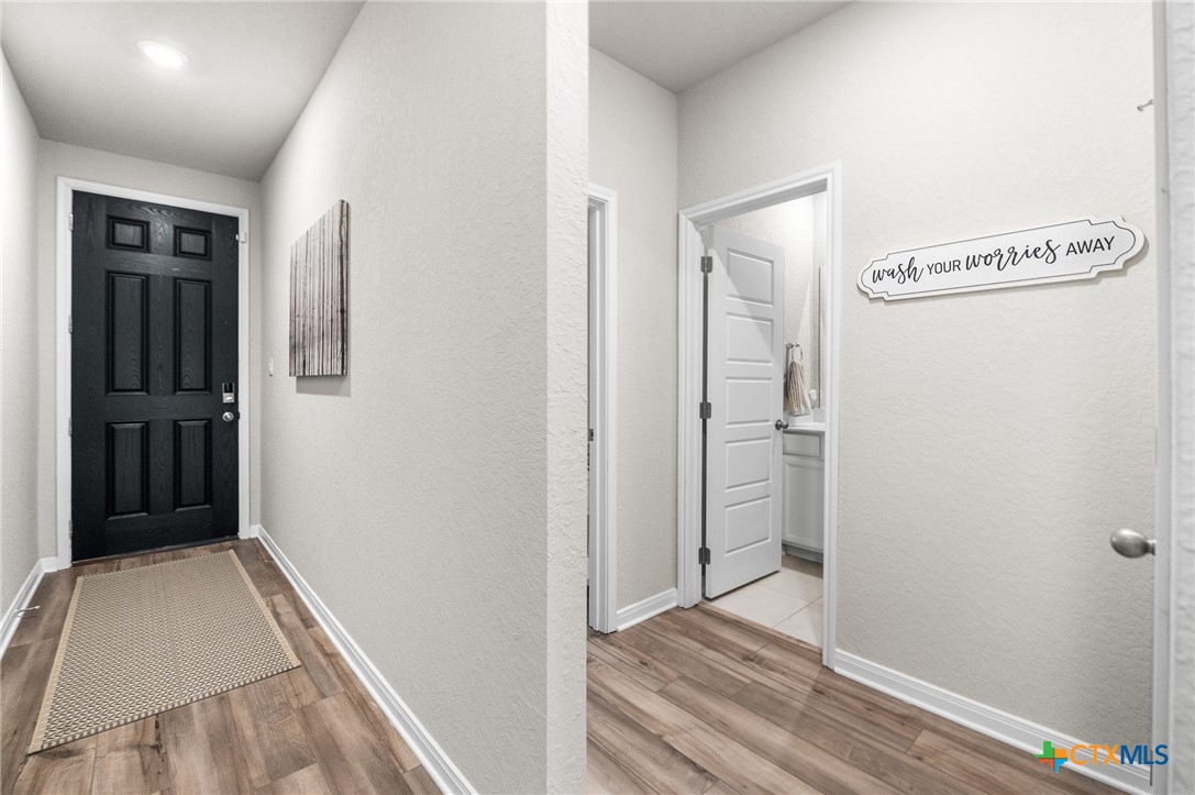 232 Colebrook Way Cibolo, TX 78108 - Photo 3 of 42 a view of a hallway with wooden floor