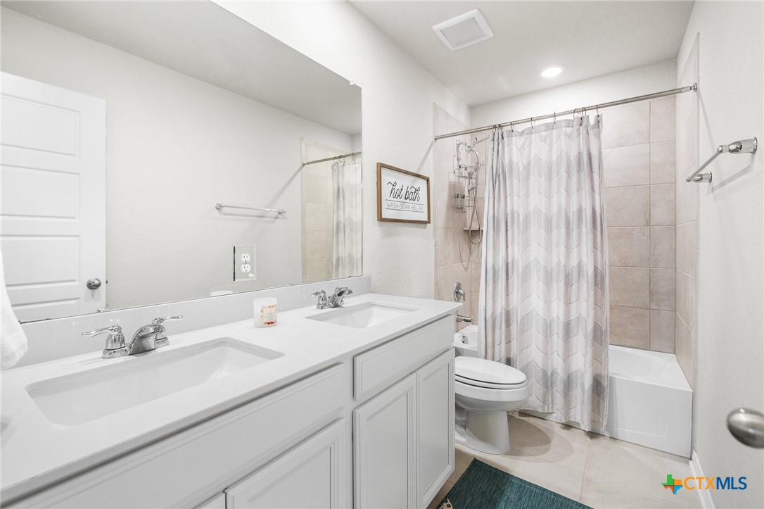 232 Colebrook Way Cibolo, TX 78108 - Photo 32 of 42 a bathroom with a sink toilet double vanity and shower