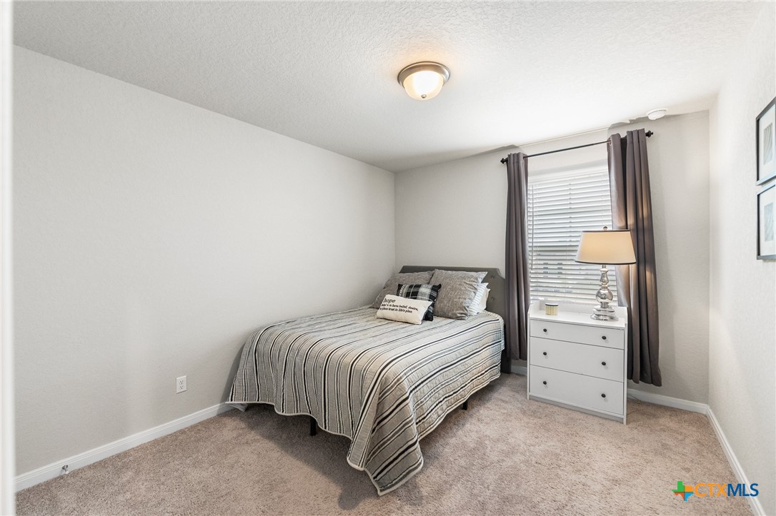 232 Colebrook Way Cibolo, TX 78108 - Photo 36 of 42 a bedroom with a bed and a window