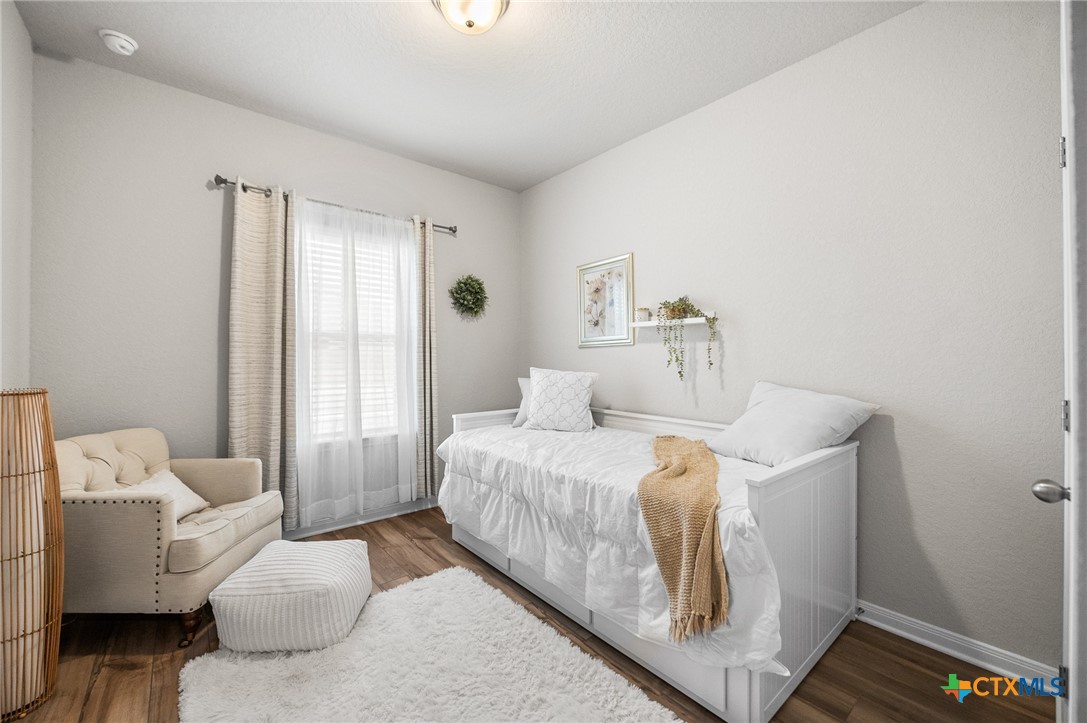 232 Colebrook Way Cibolo, TX 78108 - Photo 4 of 42 a bedroom with a bed and wooden floor
