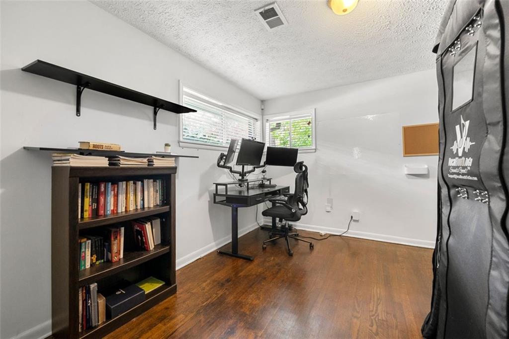 2268 Shamrock Drive Decatur, GA 30032 - Photo 24 of 31 a view of a workspace with furniture and a book shelf