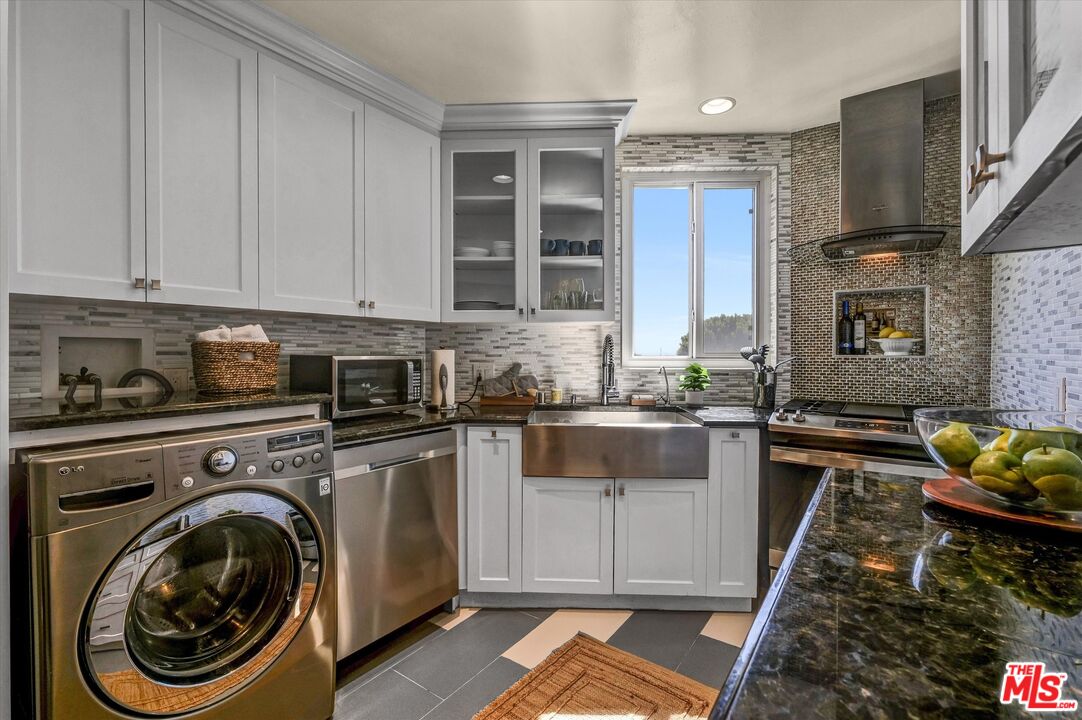 11670 Sunset Boulevard, Unit 303 Los Angeles, CA 90049 - Photo 1 of 32 a kitchen with a stove sink and cabinets