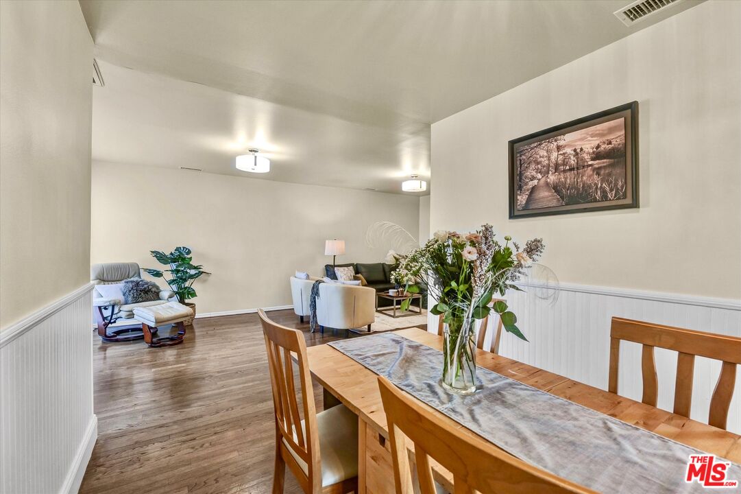 11670 Sunset Boulevard, Unit 303 Los Angeles, CA 90049 - Photo 11 of 32 a dining room with furniture and wooden floor