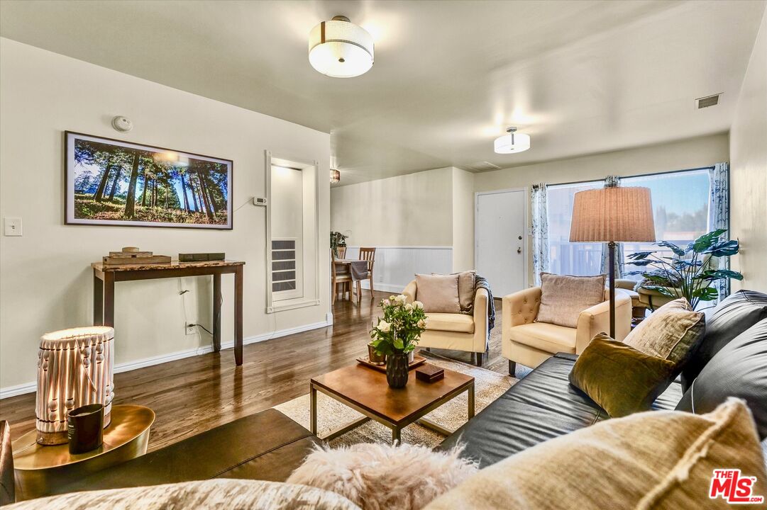 11670 Sunset Boulevard, Unit 303 Los Angeles, CA 90049 - Photo 12 of 32 a living room with furniture and wooden floor