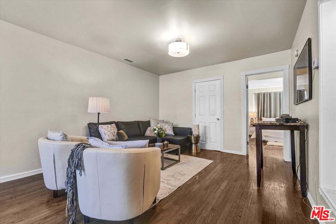 11670 Sunset Boulevard, Unit 303 Los Angeles, CA 90049 - Photo 14 of 32 a living room with furniture and a wooden floor
