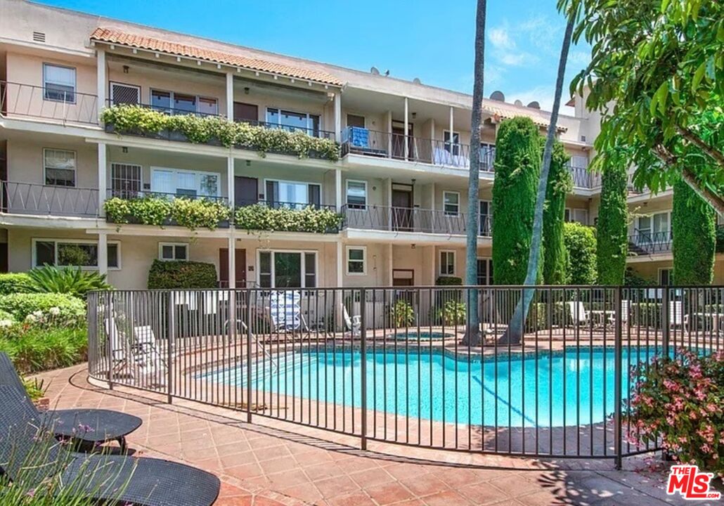 11670 Sunset Boulevard, Unit 303 Los Angeles, CA 90049 - Photo 24 of 32 a front view of a house with a garden