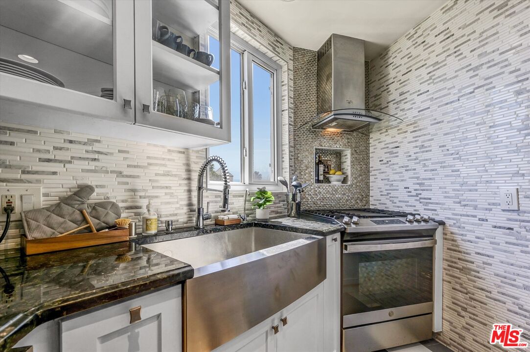 11670 Sunset Boulevard, Unit 303 Los Angeles, CA 90049 - Photo 4 of 32 a kitchen that has a sink and a stove