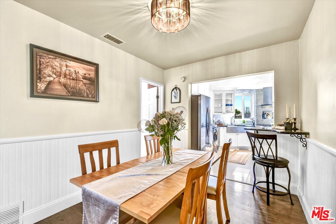 11670 Sunset Boulevard, Unit 303 Los Angeles, CA 90049 - Photo 7 of 32 a view of a dining room with furniture and wooden floor