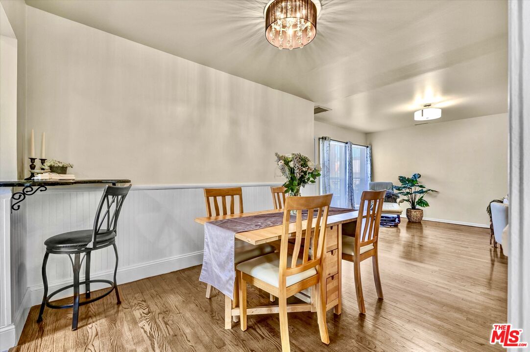 11670 Sunset Boulevard, Unit 303 Los Angeles, CA 90049 - Photo 8 of 32 a view of a dining room with furniture and wooden floor
