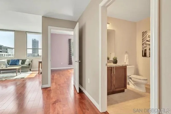 a kitchen with granite countertop kitchen island stainless steel appliances a stove a sink a refrigerator and a living room view