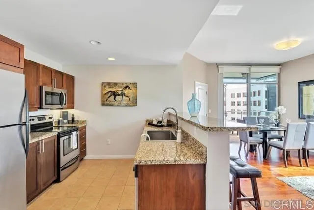 a dining room with furniture a rug and wooden floor
