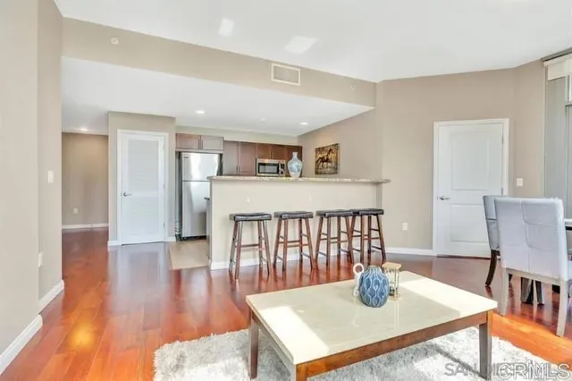 a bathroom with a granite countertop toilet sink and mirror