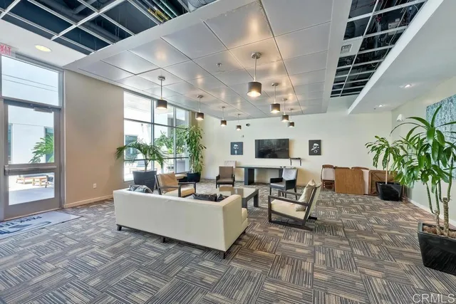 a living room with furniture and a chandelier