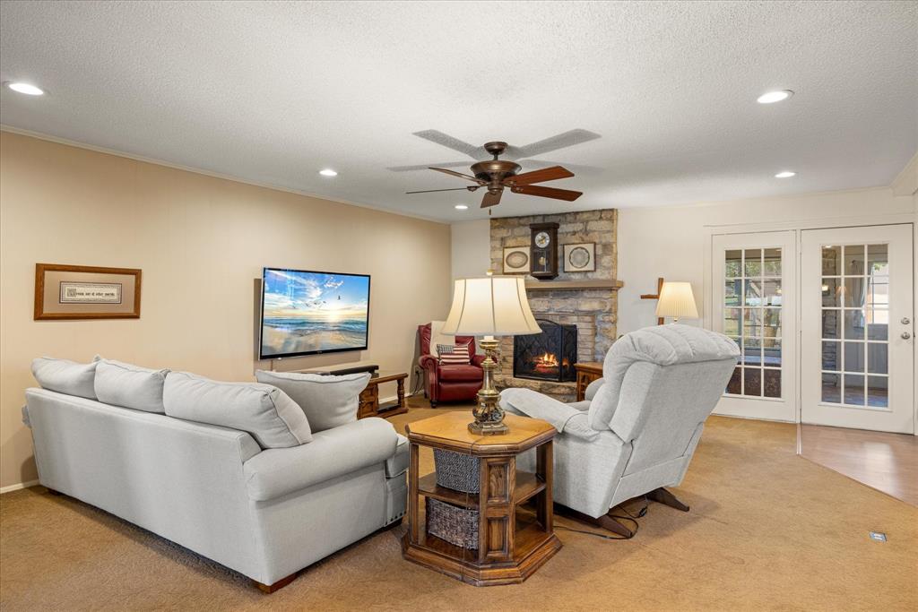 17305 Highway 281 Hico, TX 76457 - Photo 4 of 28 a living room with furniture a fireplace and a flat screen tv
