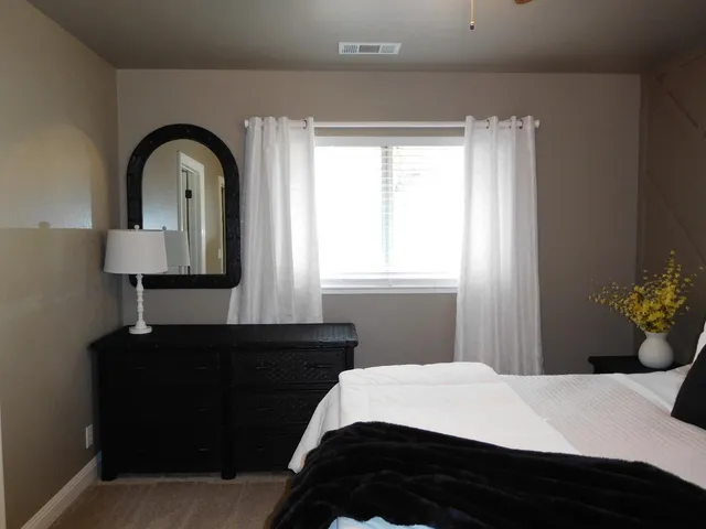 a bedroom with a bed and a lamp on table