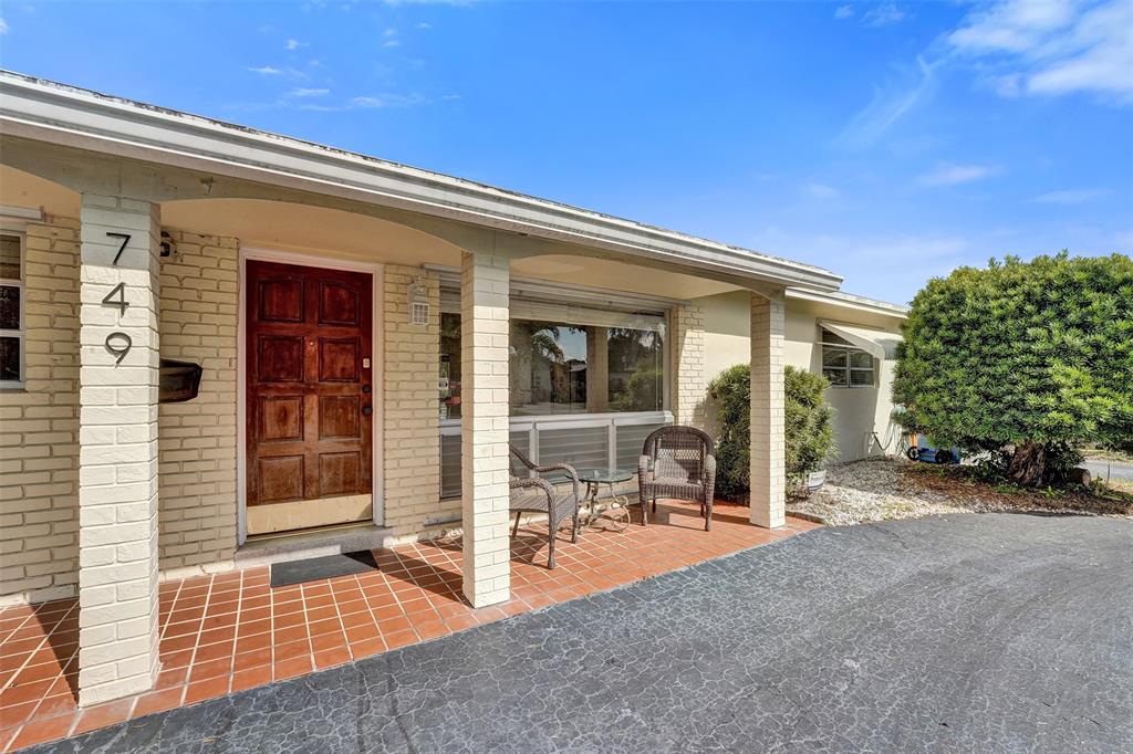 a view of a house with backyard porch and sitting area