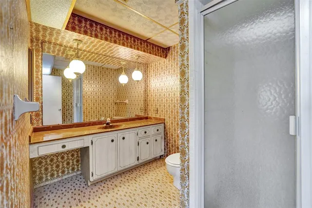 a bathroom with a sink a mirror and a shower