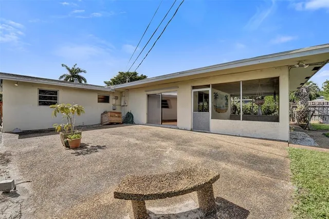 a view of a patio with table and chairs potted plants