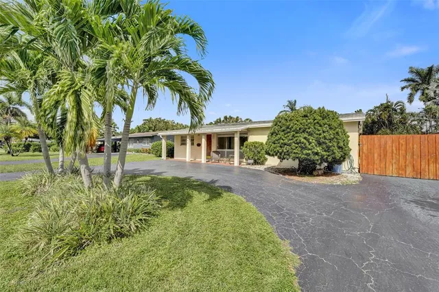 a front view of a house with yard and green space