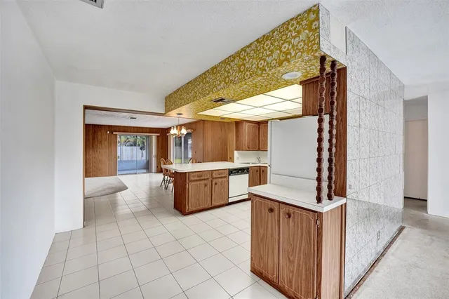 a view of a kitchen with fridge and sink