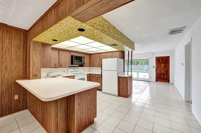 a kitchen with a sink a counter top space and stainless steel appliances