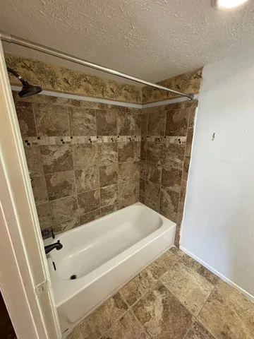 a bathroom with a bathtub and a shower