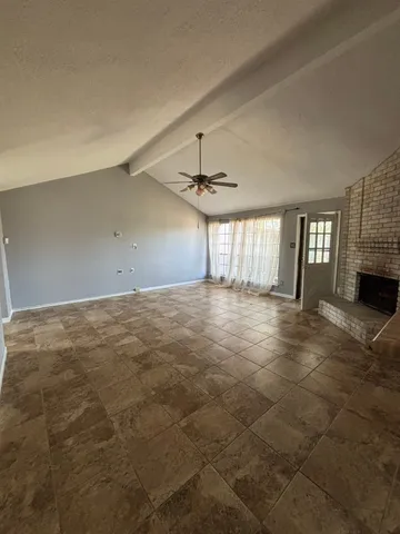 a view of empty room with fireplace