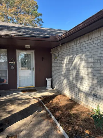 a view of backyard with wooden wall