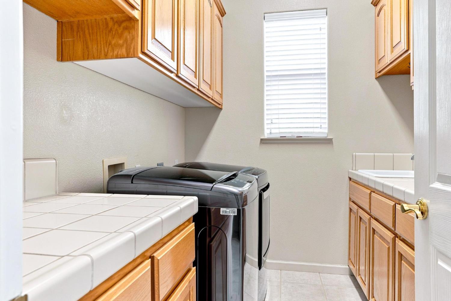 217 Rock Ridge Lane Copperopolis, CA 95228 - Photo 46 of 55 Laundry Room. Sink, cabinets, extra counter space.