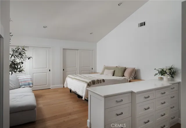 a spacious bedroom with a bed and a couch