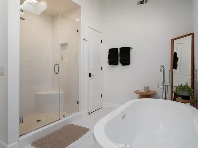a bathroom with a bathtub and a shower