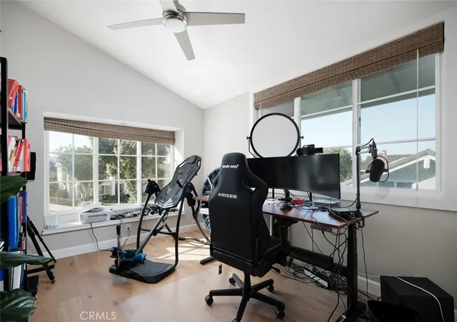 a view of a workspace with furniture and a window