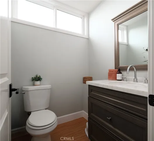 a bathroom with a toilet a sink and a window