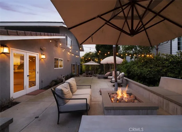a outdoor living space with patio furniture and a umbrella