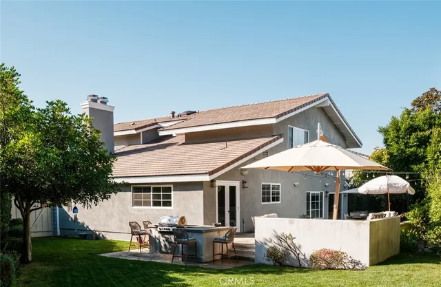 a front view of house with yard green space and outdoor seating