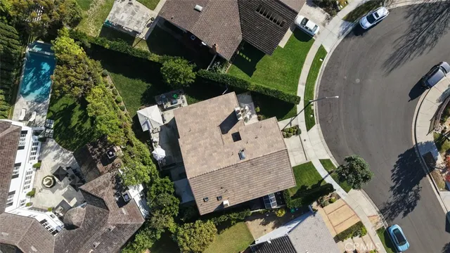 an aerial view of a house with a yard and trees