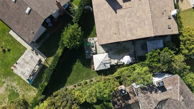 an aerial view of a house with a yard and plants