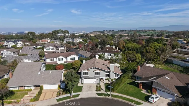 an aerial view of residential houses with city view