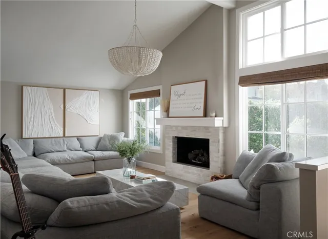 a living room with furniture a large window and a fireplace