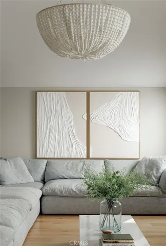 a living room with a couch and a potted plant