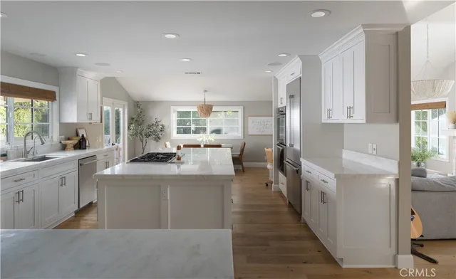 a kitchen with counter top space sink stove and refrigerator