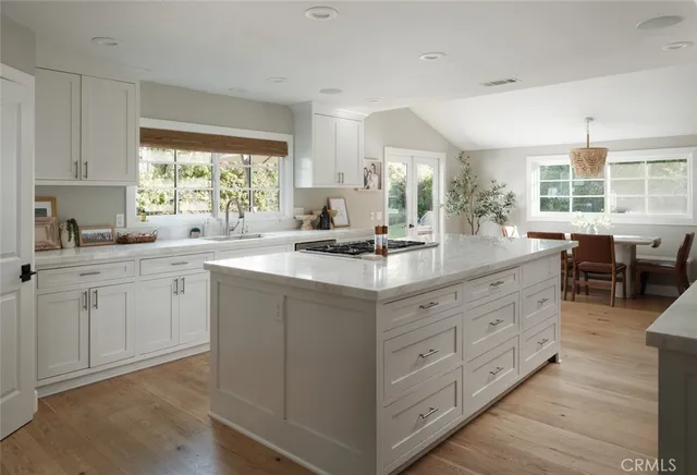 a kitchen with sink stove and cabinets