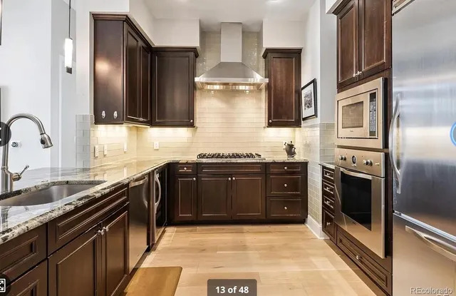 a kitchen with stainless steel appliances granite countertop a stove and a refrigerator