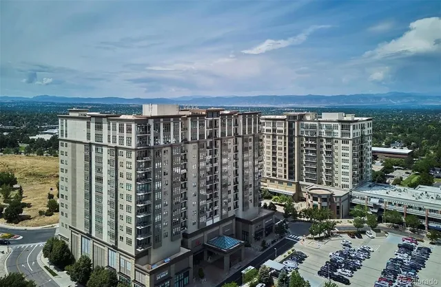 a city view from a balcony with chairs