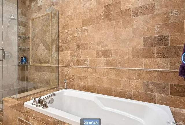 a bathroom with a bathtub and shower