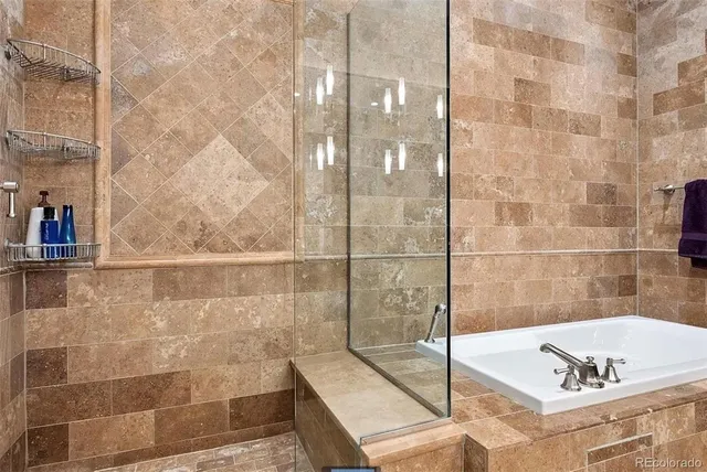 a bathroom with a bathtub and shower