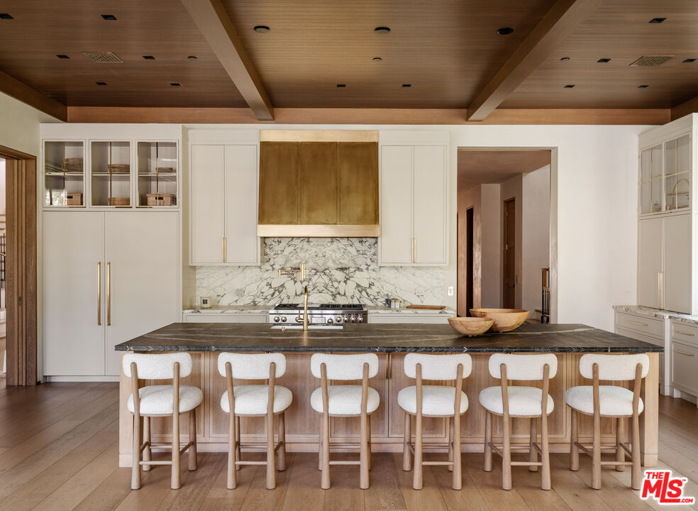 250 South Rockingham Avenue Los Angeles, CA 90049 - Photo 8 of 20 a dining room with furniture and wooden floor